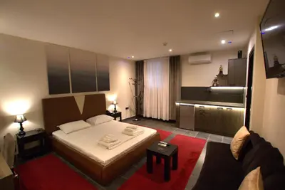 a hotel room with a bed and a couch at Deluxe Suite 212 - Castle De Paris in Athens