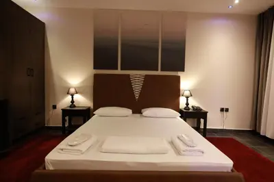 a bedroom with a large bed with two towels on it at Deluxe Suite 212 - Castle De Paris in Athens