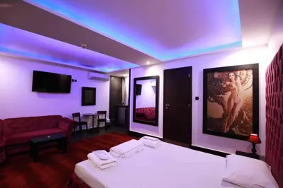 a hotel room with two beds and a couch at Deluxe Suite 213 - Castle De Paris in Athens
