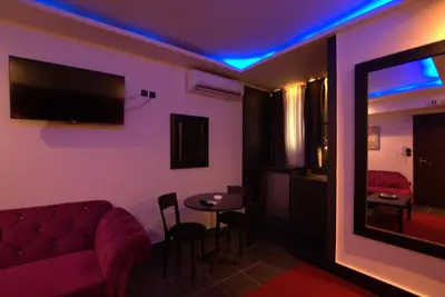 a living room with a couch and a table at Deluxe Suite 213 - Castle De Paris in Athens