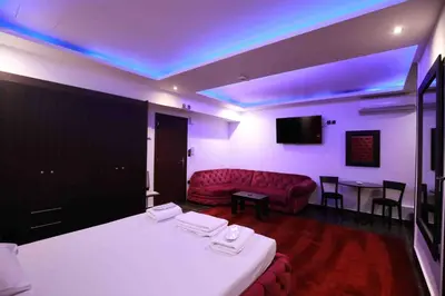 a room with a bed and a couch and a table at Deluxe Suite 213 - Castle De Paris in Athens