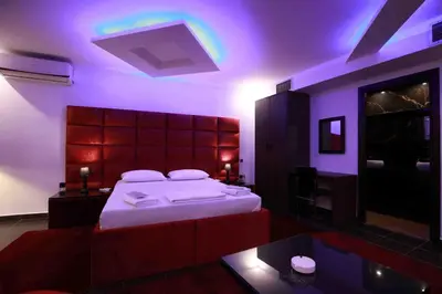 a bedroom with a large bed with a purple lighting at Deluxe Suite 214 - Castle De Paris in Athens