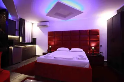 a bedroom with a large bed with a purple lighting at Deluxe Suite 214 - Castle De Paris in Athens