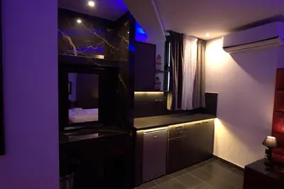 a kitchen with purple lights in a room at Deluxe Suite 214 - Castle De Paris in Athens