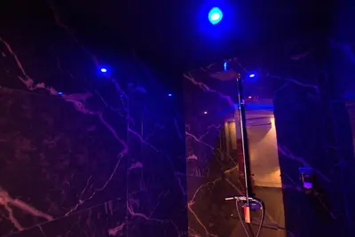 a bathroom with a mirror and purple lights at Deluxe Suite 214 - Castle De Paris in Athens