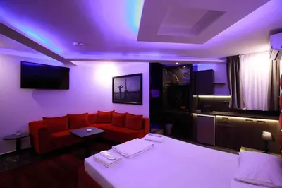 a hotel room with a bed and a couch at Deluxe Suite 214 - Castle De Paris in Athens