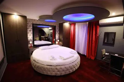 a bedroom with a large bed with a blue light at Deluxe Suite 215 - Castle De Paris in Athens