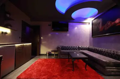 a living room with a couch and a red rug at Deluxe Suite 215 - Castle De Paris in Athens