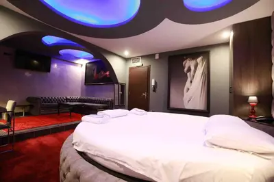 a bedroom with a large white bed with a blue ceiling at Deluxe Suite 215 - Castle De Paris in Athens