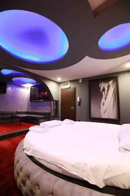 a bedroom with a large bed with blue lights on the ceiling at Deluxe Suite 215 - Castle De Paris in Athens