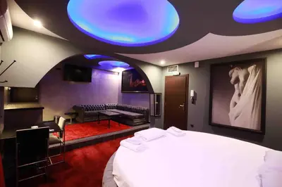 a bedroom with a large bed and a living room at Deluxe Suite 215 - Castle De Paris in Athens