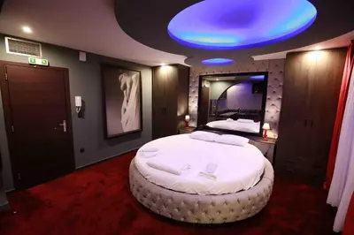 a bedroom with a large bed with a blue light at Deluxe Suite 215 - Castle De Paris in Athens