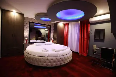 a bedroom with a large bed with a blue ceiling at Deluxe Suite 215 - Castle De Paris in Athens