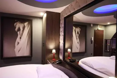 a bedroom with a bed and a large mirror at Deluxe Suite 215 - Castle De Paris in Athens