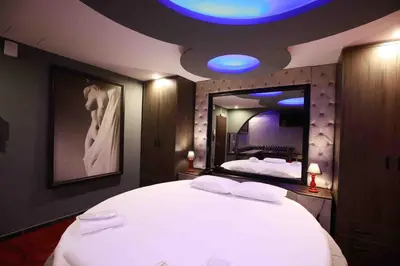 a bedroom with a large white bed with a large mirror at Deluxe Suite 215 - Castle De Paris in Athens