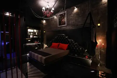 a dark room with a bed and a chandelier at Experience Room 101 - Castle De Paris in Athens