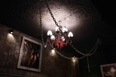 a chandelier hanging from the ceiling in a room at Experience Room 101 - Castle De Paris in Athens