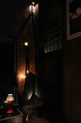 a dark room with a swing in the dark at Experience Room 101 - Castle De Paris in Athens