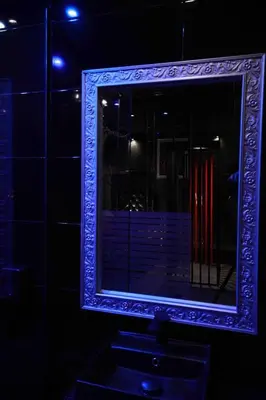 a mirror in a blue frame on a wall at Experience Room 101 - Castle De Paris in Athens