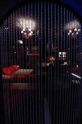 a metal fence with beads on it with a helicopter at Experience Room 102 - Castle De Paris in Athens