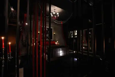 a dark room with a chandelier and a table with candles at Experience Room 103 - Castle De Paris in Athens