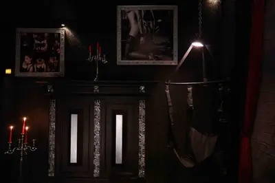 a dark room with pictures and candles on a wall at Experience Room 103 - Castle De Paris in Athens