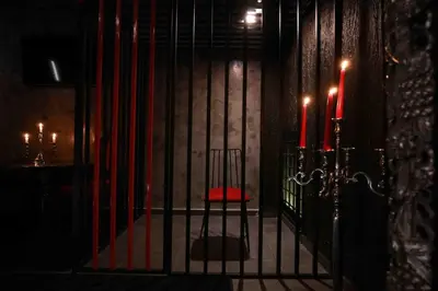 a room with a gate with two red candles at Experience Room 103 - Castle De Paris in Athens