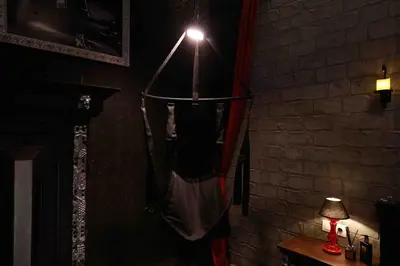 a person in a hammock in a room with a light at Experience Room 103 - Castle De Paris in Athens