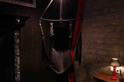 a hanging hammock in a room with a lamp at Experience Room 103 - Castle De Paris in Athens