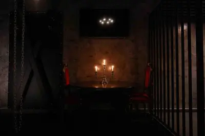 a dark room with a table with candles on it at Experience Room 103 - Castle De Paris in Athens