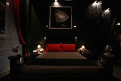 a bedroom with a bed with red pillows at Experience Room 104 - Castle De Paris in Athens