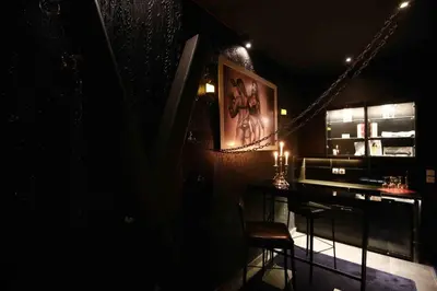 a dark room with a bar with a table and a picture at Experience Room 104 - Castle De Paris in Athens