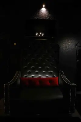 a dark room with a bed with a red pillow at Experience Room 104 - Castle De Paris in Athens