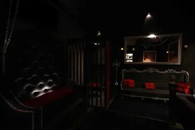 a dark room with a mirror and a couch in the dark at Experience Room 105 - Castle De Paris in Athens