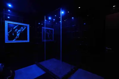 a dark room with a shower with blue lights at Experience Room 105 - Castle De Paris in Athens