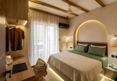 a bedroom with a large bed and a window at Rustic Boutique Apartment with Live Olive Tree & Private Parking in Athens