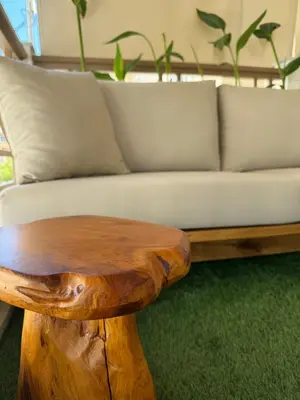 a living room with a couch and a wooden coffee table at Rustic Boutique Apartment with Live Olive Tree & Private Parking in Athens
