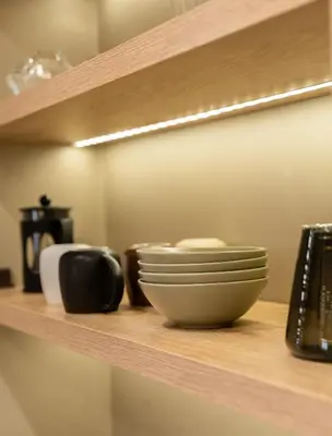 a shelf with bowls and other items on it at Rustic Boutique Apartment with Live Olive Tree & Private Parking in Athens