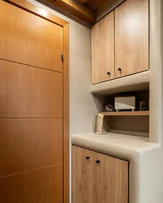 a kitchen with wooden cabinets and a shelf at Rustic Boutique Apartment with Live Olive Tree & Private Parking in Athens