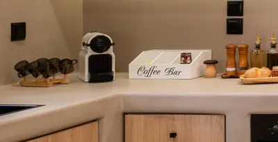 a kitchen counter with a box on top of it at Rustic Boutique Apartment with Live Olive Tree & Private Parking in Athens