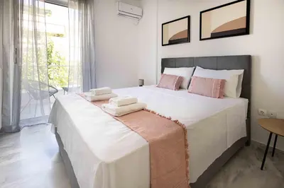 a bedroom with a large bed with towels on it at Elegant Apartment in Glyfada A1 in Athens