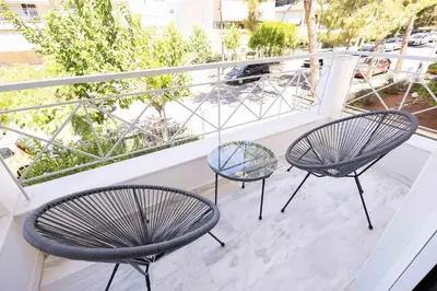 two chairs and a table on a balcony at Elegant Apartment in Glyfada A1 in Athens