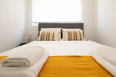 a bedroom with a large white bed with pillows at Elegant Apartment in Glyfada A1 in Athens