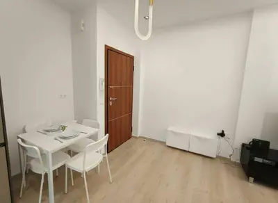 a white dining room with a white table and chairs at Coastal Elegance 1-Bedroom Hideaway by the Beach in Athens