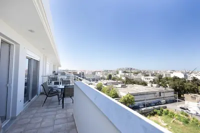 a balcony with a view of a city at Bright 2BR flat with city view in Piraeus Η6 in Piraeus