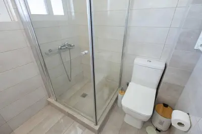 a bathroom with a shower and a toilet at Bright 2BR flat with city view in Piraeus Η6 in Piraeus