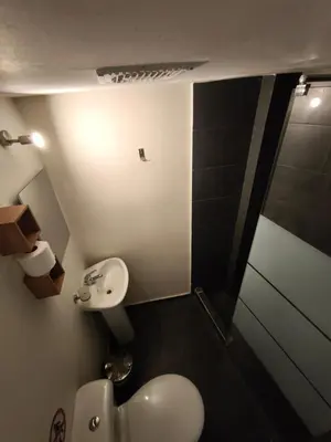 a bathroom with a toilet and a sink and a shower at Athens Commercial Premium in Athens