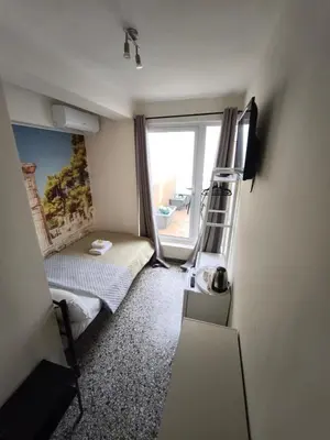 a small room with a bunk bed and a ladder at Athens Commercial Premium in Athens