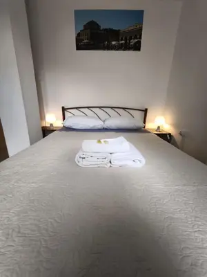 a bedroom with a bed with towels on it at Athens Commercial Premium in Athens