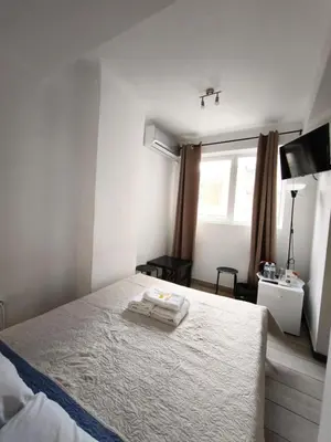 a bedroom with a bed with two towels on it at Athens Commercial Premium in Athens